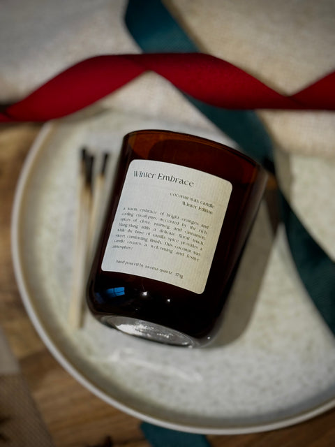 Winter Embrace refillable candle by Aroma Quartz on textured woven surface