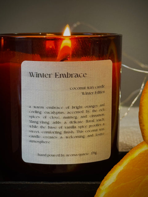 Winter Embrace — Natural Wax Refillable Candle by Aroma Quartz — styled on woven mat with botanical props