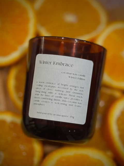 Winter Embrace candle by Aroma Quartz — smoke rising from extinguished wick