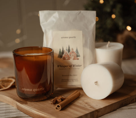 Amber refillable candle, wax refill pods and a Whisper of Winter wax melt packet with cinnamon sticks