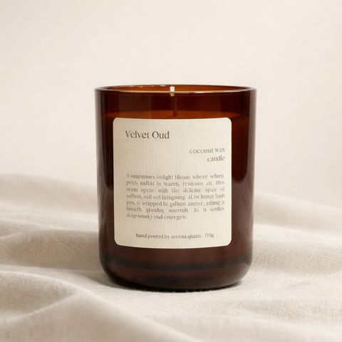Velvet Oud candle with a label on a beige fabric background
