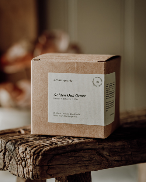 Kraft paper candle box labeled 'Golden Oak Grove' on a wooden surface.