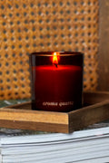 amber refillable candle engraved with 'aroma quariz' on a wooden tray with a textured background